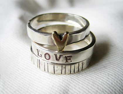 Stack of three rings with heart and etched designs by Lovebird