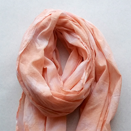 Woman's peach shibori scarf by Ruru Textiles