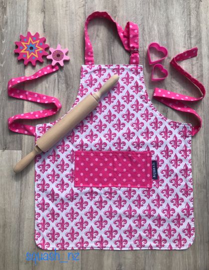Children’s apron - pink fleur-de-lis 