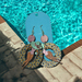 Earrings: Woman wearing a sunhat lying on a pool donut