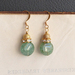 Aida earrings: green gemstone, rhinestones, and gold 