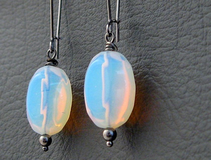 Sea Opal earrings: moon-like glass ovals on long black ear-wires