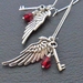 Altan earrings: cluster earrings with silver angel wings, key charms, and deep red glass 