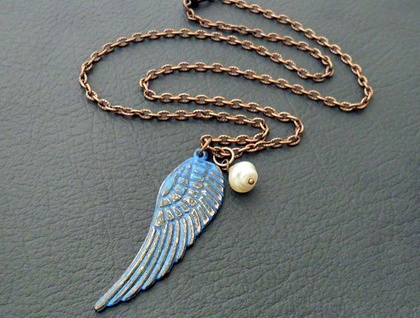 Rusty Blue Wing necklace: distressed angel-wing pendant with blue patina and cream faux pearl on copper chain