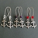 The Jester earrings — choose from clear, purple, or red
