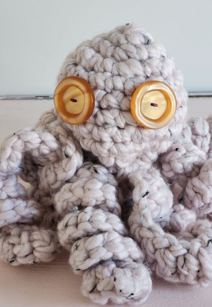 Big chunky eight legged crochet octopus with big vintage gold button eyes textured sensory toys