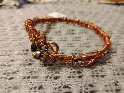 Wire wrapped bangle with small flower