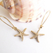 Golden Starfish earrings: lifelike, gold and white starfish charms on long ear-wires