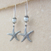 Starfish Treasure earrings in silver: lifelike, silver starfish charms with white faux pearls