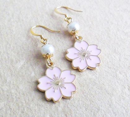 Sakura earrings: pale pink blossom charms on gold ear-hooks 