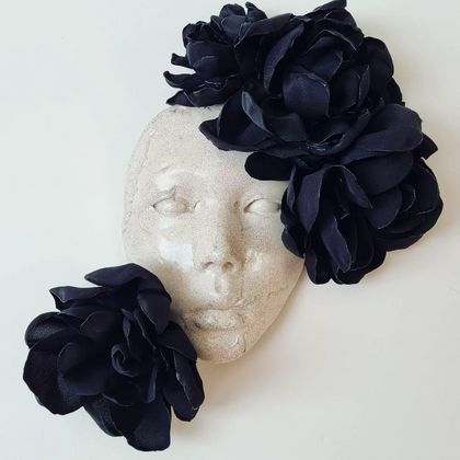 Crackle ceramic face wall hanging with black fabric flowers