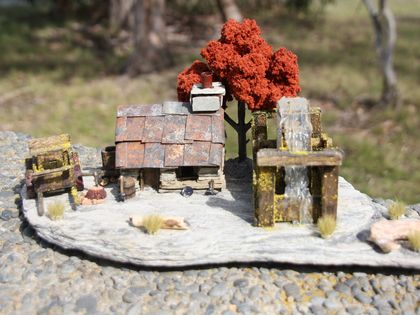 Miniature Model Stone Mining Cottage with Wagon, Water Wheel & Red tree.