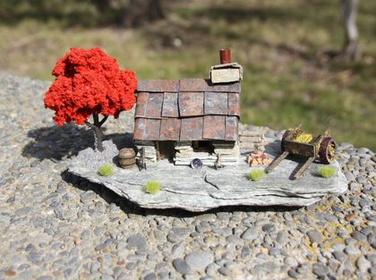 Miniature Model Stone Mining Cottage with cart & red tree.